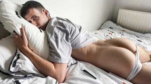 Cute British twink Cain lies back in bed in a t-shirt and a pair of white briefs that cling to every inch of his hard cock. He runs his hands over his body and strokes his dick through the thin material....