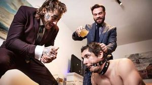 James Fox has arranged a special cuck session for his sub, Rocky Vallarta, and he sits with his feet up on ball-gagged Rocky's back until Bo Sinn arrives.