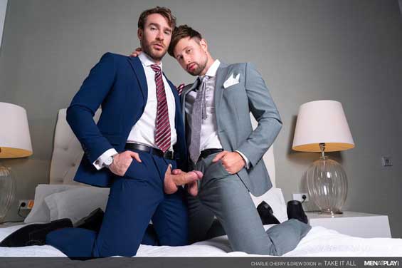 Sitting on the corner of the bed, fully suited, horned up Charlie Cherry is jerking off his monster cock through the fly of his pants. He wipes the precum off his cock with his striped tie and keeps jerking ever so gently.